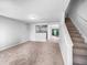 Open-concept living room with a staircase and natural light flowing, perfect for gatherings at 2705 Ramblegate Ln, Durham, NC 27705