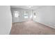 Bright living room featuring a neutral color palette, large windows and direct access to the staircase at 2705 Ramblegate Ln, Durham, NC 27705