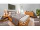 This main bedroom features a large bed, a dresser, bedside tables, new paint, and fresh carpet at 2705 Ramblegate Ln, Durham, NC 27705