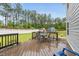 Back deck featuring a patio dining set and view of the lush fenced backyard at 2909 Landon Pines Ct, New Hill, NC 27562