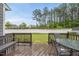 Enjoy the view from the back deck, featuring a patio dining set and peaceful backyard at 2909 Landon Pines Ct, New Hill, NC 27562
