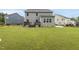 Spacious backyard featuring a well-maintained lawn, a patio, and a privacy fence at 2909 Landon Pines Ct, New Hill, NC 27562