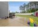 Large backyard with a concrete patio, deck, and lush lawn perfect for recreation at 2909 Landon Pines Ct, New Hill, NC 27562
