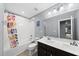 Colorful bathroom with a double vanity and playful shower curtain at 2909 Landon Pines Ct, New Hill, NC 27562