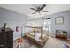 Bright bedroom features a unique bed, ceiling fan, and neutral color palette at 2909 Landon Pines Ct, New Hill, NC 27562