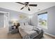 Comfortable bedroom with a queen-size bed and large window offering natural light at 2909 Landon Pines Ct, New Hill, NC 27562