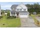 Charming two-story home featuring a white picket fence and a two-car garage with a manicured front yard at 2909 Landon Pines Ct, New Hill, NC 27562
