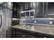 Close-up of a modern kitchen with stainless steel appliances, a gas stovetop, and sleek cabinetry at 2909 Landon Pines Ct, New Hill, NC 27562
