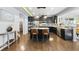 Well-lit kitchen with stainless steel appliances, dark cabinets, granite counters, and a central island with seating at 2909 Landon Pines Ct, New Hill, NC 27562