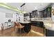 Stylish kitchen with stainless steel appliances, black cabinets, granite counters, and an island with bar stools at 2909 Landon Pines Ct, New Hill, NC 27562