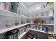 Walk-in pantry with ample shelving, neatly stocked with a variety of food items and kitchen essentials at 2909 Landon Pines Ct, New Hill, NC 27562