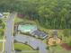 Aerial view of community pool and park with mature trees and manicured landscaping at 2909 Landon Pines Ct, New Hill, NC 27562