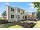 Back exterior of the house with multi-level deck and large manicured backyard at 300 Quarryrock Road Rd, Holly Springs, NC 27540