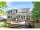 Beautiful deck featuring outdoor dining space in landscaped backyard with green grass at 300 Quarryrock Road Rd, Holly Springs, NC 27540