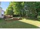 Spacious backyard featuring a multi-level deck and a well-manicured lawn with garden at 300 Quarryrock Road Rd, Holly Springs, NC 27540