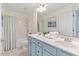 Bathroom featuring a double sink vanity with ample counter space and white shower at 300 Quarryrock Road Rd, Holly Springs, NC 27540
