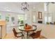 Inviting dining area featuring lots of natural light and a view into the living room and fireplace at 300 Quarryrock Road Rd, Holly Springs, NC 27540