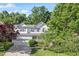 Beautiful two-story home with white siding, blue shutters, a well-maintained lawn, and mature trees at 300 Quarryrock Road Rd, Holly Springs, NC 27540
