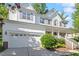 Charming two-story home featuring a two-car garage, covered porch, and white siding with blue shutters at 300 Quarryrock Road Rd, Holly Springs, NC 27540