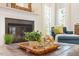 Cozy living room with a fireplace and comfortable seating, perfect for relaxing and entertaining guests at 300 Quarryrock Road Rd, Holly Springs, NC 27540