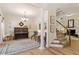 Elegant living room showcasing a piano, staircase, hardwood floors, and decorative furnishings at 300 Quarryrock Road Rd, Holly Springs, NC 27540