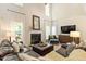 Comfortable living room with high ceilings, a fireplace, plush seating, and ample natural light at 300 Quarryrock Road Rd, Holly Springs, NC 27540