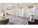 Bright living room featuring hardwood floors, large windows, and a piano at 300 Quarryrock Road Rd, Holly Springs, NC 27540