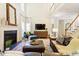 Inviting living room with a fireplace, high ceilings, comfortable seating, and staircase access at 300 Quarryrock Road Rd, Holly Springs, NC 27540