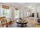 Spacious living room with hardwood floors, large windows, and decorative columns at 300 Quarryrock Road Rd, Holly Springs, NC 27540