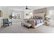 Bright main bedroom with tufted headboard, a sitting bench, and neutral tones creating a serene retreat at 300 Quarryrock Road Rd, Holly Springs, NC 27540
