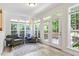 Bright sunroom with lots of natural light, comfortable seating, and deck access through glass paneled French doors at 300 Quarryrock Road Rd, Holly Springs, NC 27540