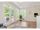 Sunroom with multiple windows, deck access, and hardwood floors creates a relaxing, inviting space at 300 Quarryrock Road Rd, Holly Springs, NC 27540