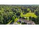 Overhead shot of suburban homes nestled in a lush, green area with a mix of trees and open fields at 3027 Maple Ave # U1, Burlington, NC 27215