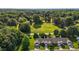 Overhead shot of suburban homes nestled in a lush, green area with a mix of trees and open fields at 3027 Maple Ave # U1, Burlington, NC 27215