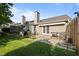 Spacious backyard featuring a patio with outdoor seating and grill, separated by wood fence at 3027 Maple Ave # U1, Burlington, NC 27215