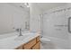 A well-lit bathroom includes a shower and bathtub combo with grab bars and a vanity at 3027 Maple Ave # U1, Burlington, NC 27215