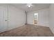 An airy bedroom features neutral carpet with an ensuite bathroom and ample closet space at 3027 Maple Ave # U1, Burlington, NC 27215