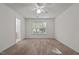 An airy bedroom featuring neutral carpet with an ensuite bathroom and a large window at 3027 Maple Ave # U1, Burlington, NC 27215