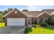 Charming brick home with a two-car garage, landscaped lawn, and inviting front porch at 3027 Maple Ave # U1, Burlington, NC 27215