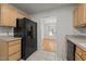 Functional kitchen with ample storage and a view into the dining area at 3027 Maple Ave # U1, Burlington, NC 27215