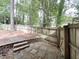 Landscaped backyard featuring a stone patio, retaining wall, and a wooden fence for added privacy at 3205 Broyhill Cir, Raleigh, NC 27604