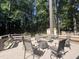 Backyard deck area featuring a fire pit, a seating area, and surrounded by tall trees at 3205 Broyhill Cir, Raleigh, NC 27604