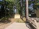 Backyard shed with a window, surrounded by tall trees, and adjacent to a wooden deck at 3205 Broyhill Cir, Raleigh, NC 27604