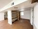 Finished basement featuring laminate flooring, built-in shelving, and stairs at 3205 Broyhill Cir, Raleigh, NC 27604