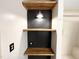 Bathroom shelving and decor featuring a black accent wall and overhead lighting at 3205 Broyhill Cir, Raleigh, NC 27604