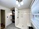 Bathroom featuring gray tile, a new-looking shower, wood shelves, and natural light from the window at 3205 Broyhill Cir, Raleigh, NC 27604