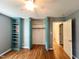 This bedroom has hardwood floors, turquoise shelving, and an open closet with rods for hanging clothes at 3205 Broyhill Cir, Raleigh, NC 27604