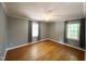 This bedroom has hardwood floors, neutral paint, a ceiling fan, and natural light from two windows at 3205 Broyhill Cir, Raleigh, NC 27604
