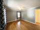 This bedroom has hardwood floors, neutral paint, a ceiling fan, and natural light from one window at 3205 Broyhill Cir, Raleigh, NC 27604