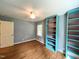 Bedroom features hardwood floors, built-in shelving, natural light, and neutral paint at 3205 Broyhill Cir, Raleigh, NC 27604